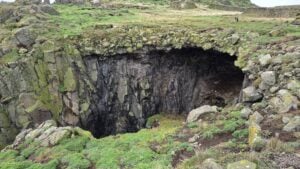 Natural rock arch and cave in the grassland, Isle of May