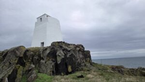 White beacon tower on volcanic rocks, Isle of May